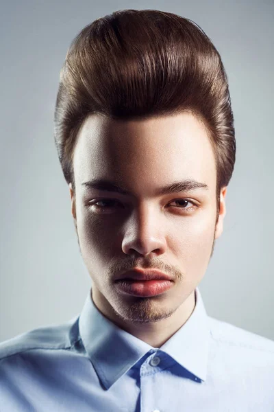 Portrait of young man with retro classic pompadour hairstyle. studio shot. looking at camera. — Stock Image Portrait of young man with retro classic pompadour hairstyle. studio shot. looking at camera. Royalty Free Stock Images