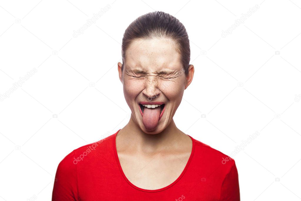 Portrait of crazy funny woman in red t-shirt with freckles and tongue. closed eyes, studio shot. isolated on white background. 