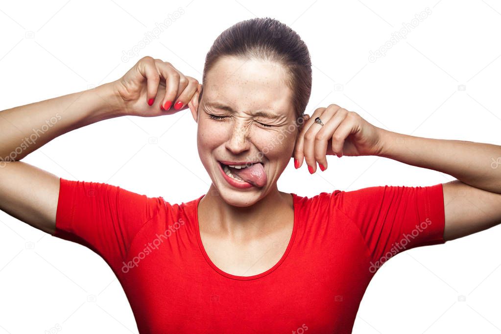 Portrait of crazy funny woman in red t-shirt with freckles. looking at camera, studio shot. isolated on white background. 