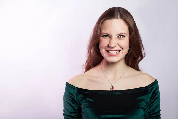 Portrait of angry woman with freckles and classic green dress. studio shot on silver gray background. — Stock Image Portrait of angry woman with freckles and classic green dress. studio shot on silver gray background. Stock Photo