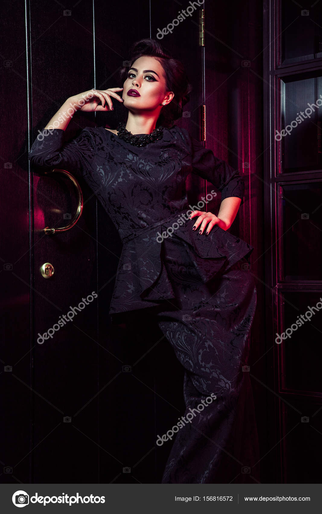 Portrait Of Beautiful Fashion Model In Classic Black Dress