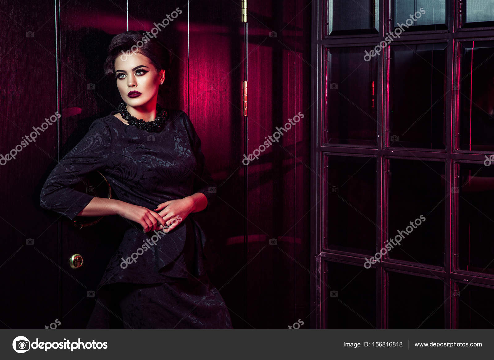 Portrait Of Beautiful Fashion Model In Classic Black Dress