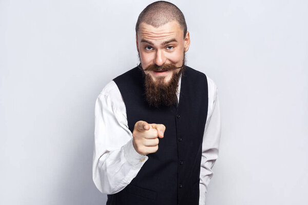 Hey You. Handsome businessman with beard and handlebar mustache looking at camera. studio shot, on gray background.