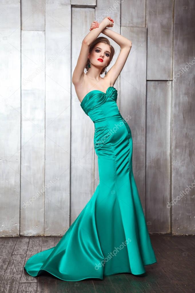 Fashion beauty photo shot of beautiful model in green dress with makeup and hairstyle. 