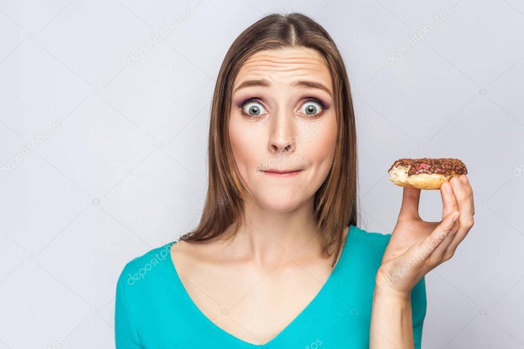 Portrait of beautiful girl with chocolate donuts. 