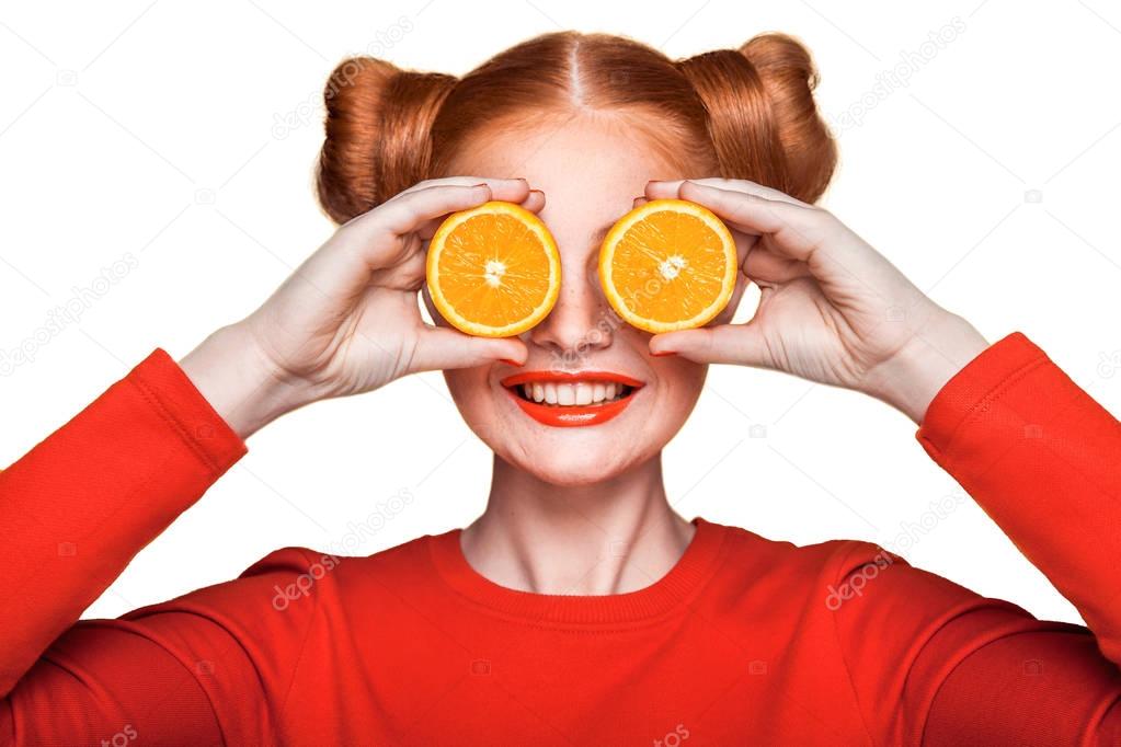 Young beautiful girl with orange.