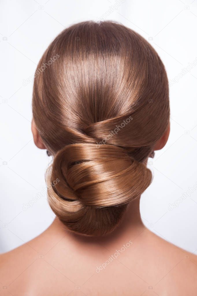 Back view of beautiful woman with creative elegant hairstyle