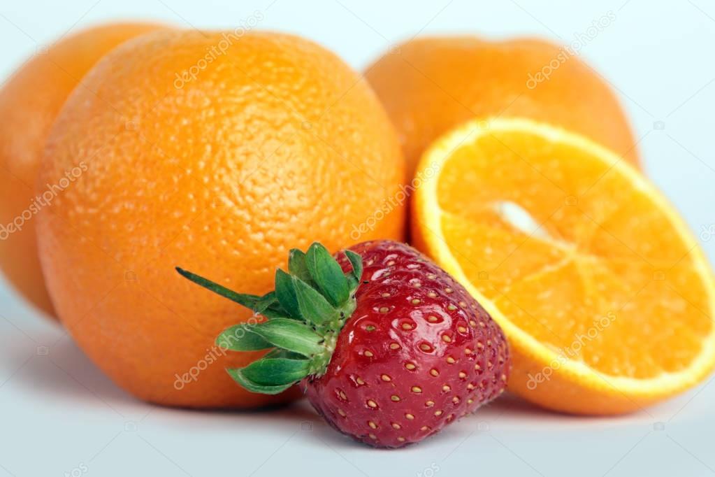 Orange, strawberries on white background