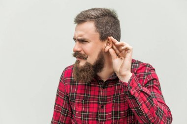 I can not hear you. Young adult bearded man listen clipart