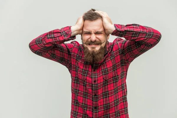 Terrible headache. Young adult man touching his head with hands — Stock Photo, Image