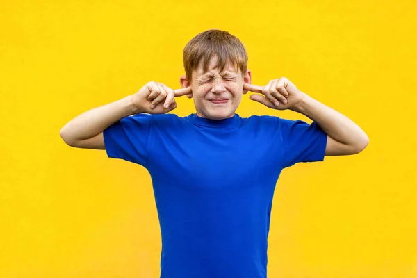 I dont want hear you! Sadness ginger boy holding fingers on ea — Stock Image I dont want hear you! Sadness ginger boy holding fingers on ea Stock Image