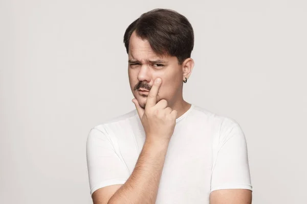 Sospecha, concepto de desconfianza. Hombre mirando a la cámara y tocando —  Fotos de Stock