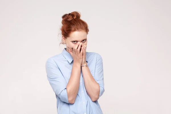 Shame and liar concept. Red haired woman covering mouth with bot — Stock Photo, Image