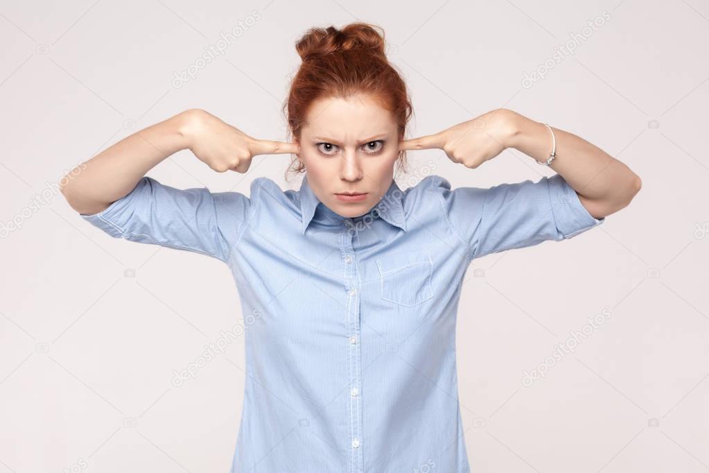 I do not want to hear from you! Aggressive ginger woman holding 