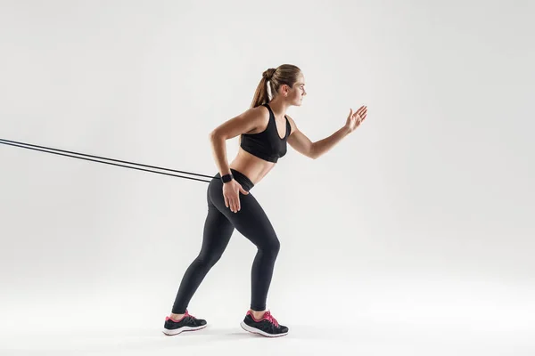 Athletic woman with resistance band — Stock Photo, Image
