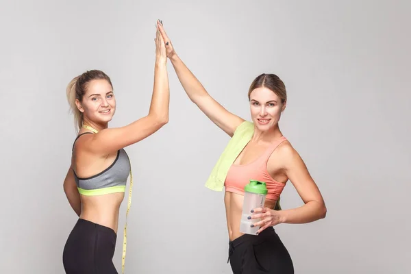 Two blonde sexy women rejoicing finish hard training — Stock Photo, Image