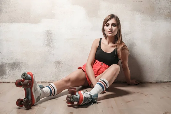 Attractive Woman Sitting Floor Roller Skating Looking Camera Studio Shot — Stock Photo, Image