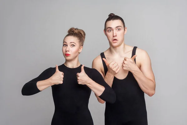 Couple Dancers Leotards Collected Hair Showing Sign Camera Gray Background — Stock Photo, Image