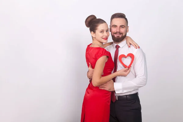 Hermosa Pareja Abrazando Sosteniendo Corazón Rojo Sobre Fondo Gris Concepto — Foto de Stock