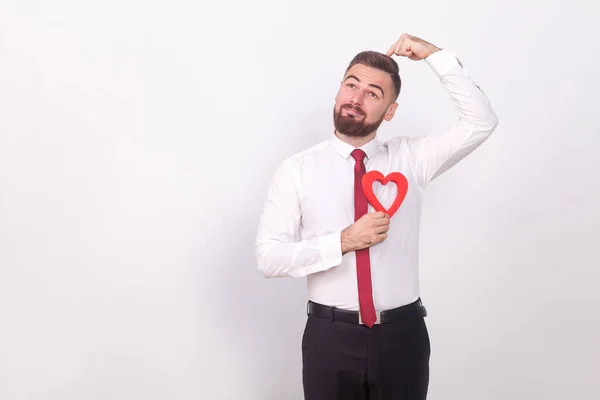 Pensativo Hombre Negocios Sosteniendo Corazón Decorativo Posándose Sobre Fondo Gris — Foto de Stock