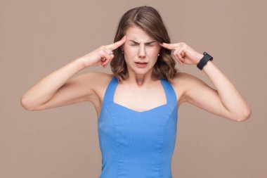 unhappy businesswoman touching head by fingers while having headache on light brown background, migraine concept  clipart