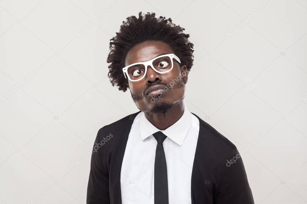 portrait funny man in white glasses grimacing at camera 