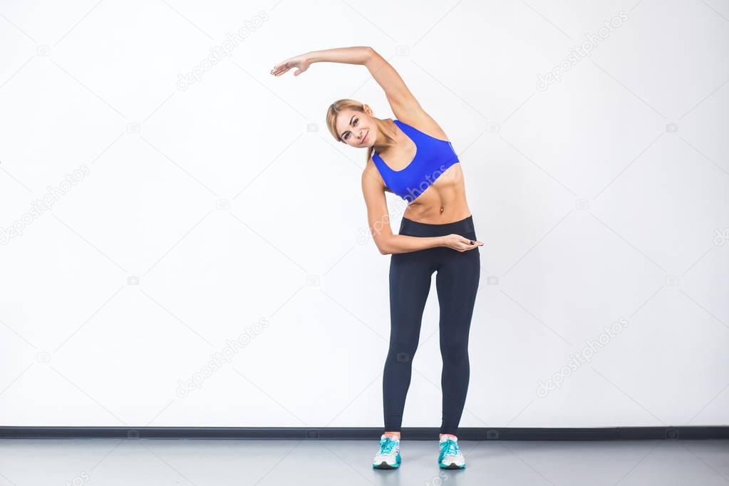 blonde woman doing fitness exercise while tilting in side