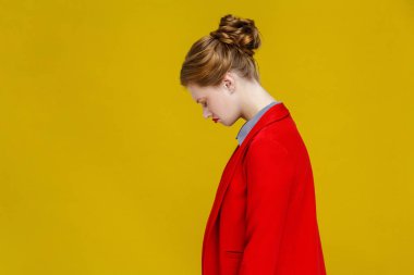 side view of frustrated redhead businesswoman in red jacket on yellow background clipart