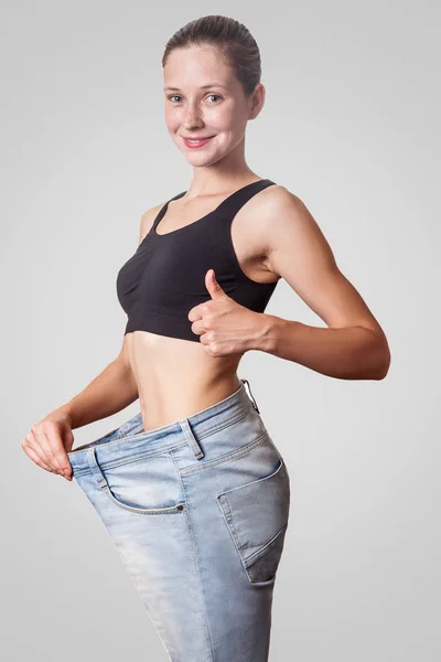 Close Slim Waist Young Woman Big Jeans Showing Thumb Successful — Stock Photo, Image