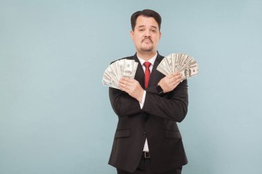 wealthy successful businessman holding dollar banknotes on light blue background clipart
