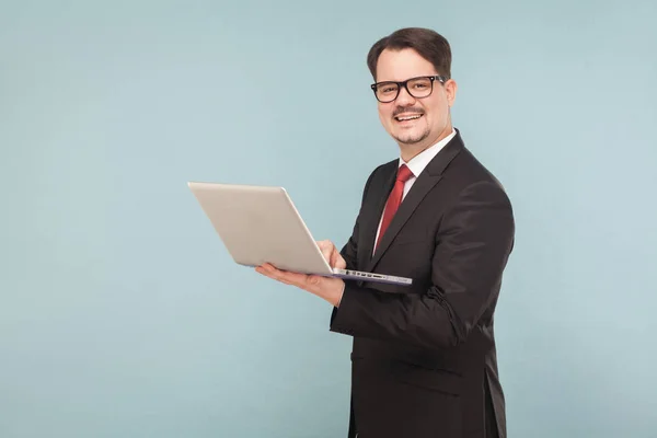 Smiling Businessman Suit Holding Laptop Light Blue Background — Stock Photo, Image