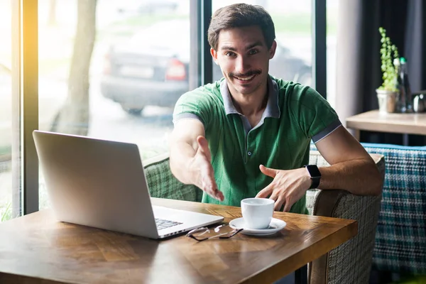 Young Happy Businessman Green Shirt Looking Camera Giving Hand Greeting — Stock Photo, Image