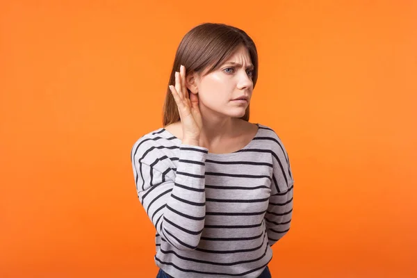 Portrait of attentive nosy young woman with brown hair in long s — Stock Photo, Image