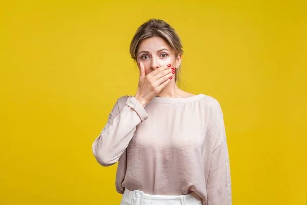 Portrait of intimidated young woman with fair hair in casual bei — Stock Photo, Image