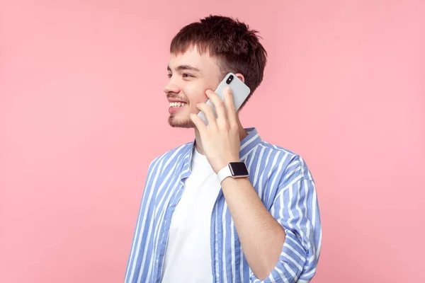 Bilde av positiv brunhåret mann som snakker i telefon – stockfoto