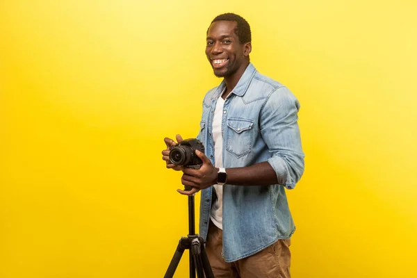 Portrait of excited motivated photographer posing professional d