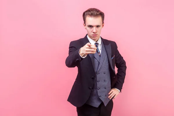 Hey you! Portrait of irritated bossy young businessman in tuxedo