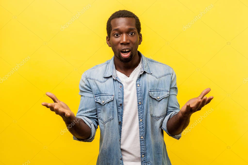How could you. Portrait of unpleasantly surprised man in denim casual shirt standing with raised hands and amazed face asking why"d you do that, indignant annoyed expression. indoor studio shot