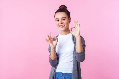 I'm okay! Portrait of positive brunette teenage girl showing ok  clipart