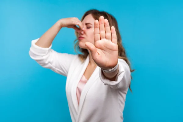 Bad smell. Portrait of woman pinching her nose and showing stop — Stock Photo, Image