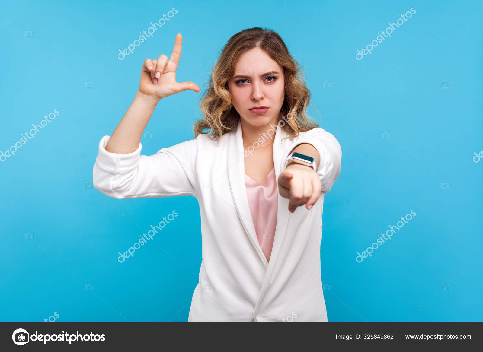 You are loser. Portrait of irritated woman doing loser gesture, Royalty  Free Photo, Stock Image by © khosrork #325849862