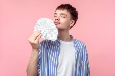 Portrait of dreamy rich brown-haired man smelling money. indoor  clipart