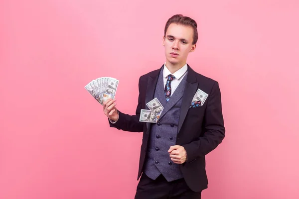 Portrait of wealthy rich man holding money and looking arrogant — Stock Photo, Image