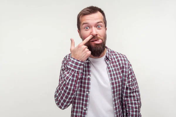 Portrait of funny silly bearded man showing tongue with comical — Stockfoto