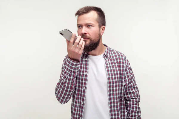 Virtual assistant. Portrait of serious bearded man talking to mo — Stock Photo, Image