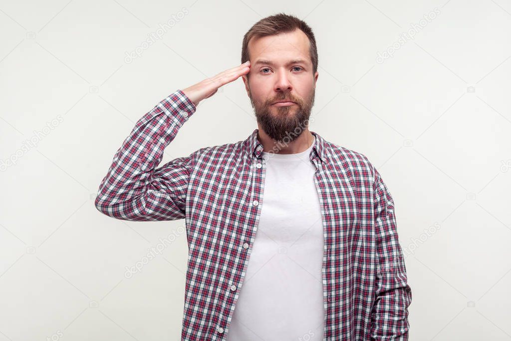 Yes sir! Portrait of young patriotic man making salute gesture a