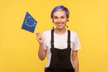 European union flag. Portrait of cheerful hipster girl holding E