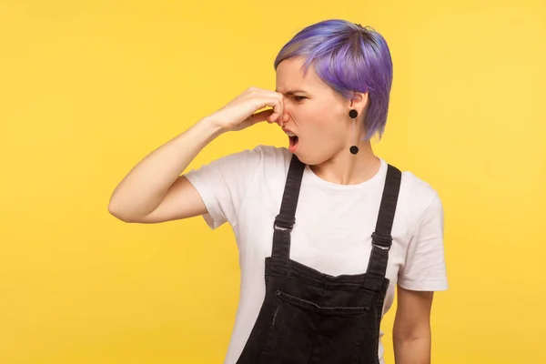 Bad smell. Portrait of displeased hipster girl pinching her nose — Stock Photo, Image