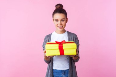 Holiday present. Portrait of positive teenage brunette girl hold clipart