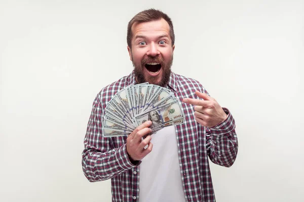 Portrait of amazed satisfied bearded man pointing at dollar bank — 스톡 사진